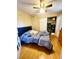 Cozy bedroom with wood floors, ceiling fan, and organized closet at 2047 Dixie Belle Dr # 2047 T, Orlando, FL 32812