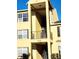 Close-up of building exterior with yellow walls and metal railings at 2047 Dixie Belle Dr # 2047 T, Orlando, FL 32812