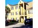 A well-maintained condo with palm trees and parking, set on a clear and sunny day at 2047 Dixie Belle Dr # 2047 T, Orlando, FL 32812