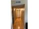 Hallway with hardwood floors, white doors, and overhead lighting at 2047 Dixie Belle Dr # 2047 T, Orlando, FL 32812