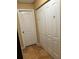 Hallway features neutral walls and white closet doors, and large format floor tiling at 2047 Dixie Belle Dr # 2047 T, Orlando, FL 32812