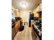 Functional kitchen with granite countertops, wooden cabinets, and appliances at 2047 Dixie Belle Dr # 2047 T, Orlando, FL 32812