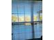 Bright view through window with horizontal blinds, showcasing the outside landscape at 2047 Dixie Belle Dr # 2047 T, Orlando, FL 32812