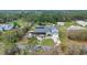 Aerial view of the house and surrounding property, showing the landscaping, pond, and RV parking area at 2086 Blackfoot Trl, St Cloud, FL 34771