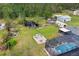 Aerial view of the pool, pond, fire pit, and outdoor entertaining area at 2086 Blackfoot Trl, St Cloud, FL 34771