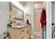 Bathroom featuring a vanity with a dark countertop and a tile shower at 2086 Blackfoot Trl, St Cloud, FL 34771