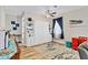 Bedroom featuring a Murphy bed, wood flooring, blue accents, and natural light at 2086 Blackfoot Trl, St Cloud, FL 34771