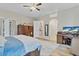 Bedroom featuring a desk, wood floors and serene decor at 2086 Blackfoot Trl, St Cloud, FL 34771