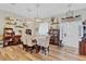 Well-lit dining room features hardwood floors, stylish chandeliers, and decorative shelving at 2086 Blackfoot Trl, St Cloud, FL 34771