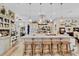 Large kitchen island with bar seating and modern stainless steel range hood at 2086 Blackfoot Trl, St Cloud, FL 34771