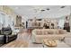 Open-concept living space featuring a comfortable couch, ceiling fan and kitchen in the background at 2086 Blackfoot Trl, St Cloud, FL 34771