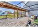 Outdoor patio with pavers, partial screening, and view of backyard at 2086 Blackfoot Trl, St Cloud, FL 34771