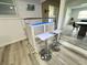 Modern bar area with a snack bar, white stools, and access to a dining area at 2326 S Peninsula Dr, Daytona Beach, FL 32118