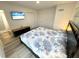 Comfortable bedroom features luxury vinyl plank flooring, TV, and ensuite bathroom at 2326 S Peninsula Dr, Daytona Beach, FL 32118