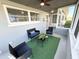Cozy screened-in porch with comfortable seating and a welcome atmosphere at 2326 S Peninsula Dr, Daytona Beach, FL 32118