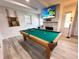 Recreation room featuring a pool table, light gray floors, and a fireplace, perfect for entertaining at 2326 S Peninsula Dr, Daytona Beach, FL 32118