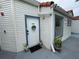 Apartment 203 exterior with potted plants and storm door at 2560 Woodgate Blvd # 203, Orlando, FL 32822