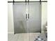 Gray double barn doors installed inside the home and positioned between rooms at 2560 Woodgate Blvd # 203, Orlando, FL 32822