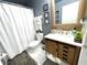 Bathroom with wood vanity, sliding barn door, updated fixtures and a walk-in shower at 2560 Woodgate Blvd # 203, Orlando, FL 32822