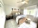 Bedroom featuring neutral decor, vaulted ceilings, a comfy bed and bright natural light at 2560 Woodgate Blvd # 203, Orlando, FL 32822