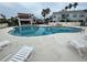 Large community pool with lounge chairs surrounded by palm trees and well kept grounds at 2560 Woodgate Blvd # 203, Orlando, FL 32822