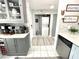 Hallway between kitchen and laundry with stacked washer/dryer and matching tile at 2560 Woodgate Blvd # 203, Orlando, FL 32822