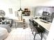 Modern kitchen with stainless steel appliances, updated cabinets and countertops, and a breakfast bar at 2560 Woodgate Blvd # 203, Orlando, FL 32822