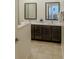 Bathroom boasting dual sinks, dark wood cabinets, and a modern design at 2652 Corvette Ln, Kissimmee, FL 34746