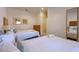 Comfortable bedroom featuring two beds, dresser, mirror, and a serene atmosphere at 2652 Corvette Ln, Kissimmee, FL 34746