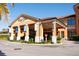 Inviting entrance of Regal Oaks featuring covered drop-off and lush landscaping at 2652 Corvette Ln, Kissimmee, FL 34746