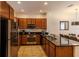Modern kitchen featuring stainless steel appliances, dark cabinets, and sleek countertops at 2652 Corvette Ln, Kissimmee, FL 34746