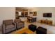 Open-concept living area with comfortable seating, a dining table, and a modern kitchen with stainless appliances at 2652 Corvette Ln, Kissimmee, FL 34746