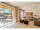 Cozy living room with tile floors, comfortable seating, and a large sliding glass door to the outdoor patio at 2652 Corvette Ln, Kissimmee, FL 34746