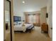 Serene main bedroom with plush carpet, a king-size bed, and a bright window view at 2652 Corvette Ln, Kissimmee, FL 34746