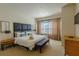 Comfortable main bedroom with a king bed, accent bench, and soft, natural lighting at 2652 Corvette Ln, Kissimmee, FL 34746