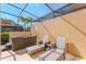 Screened patio with hot tub and lounge chairs, perfect for outdoor relaxation at 2652 Corvette Ln, Kissimmee, FL 34746