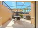 Relaxing screened-in patio featuring an outdoor dining area and private hot tub at 2652 Corvette Ln, Kissimmee, FL 34746