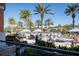 Community pool surrounded by palm trees, lounge chairs, and blue umbrellas at 2652 Corvette Ln, Kissimmee, FL 34746