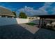 This backyard features a putting green, a white fence, and an open patio area for outdoor enjoyment at 2822 Moultrie Creek Dr, Kissimmee, FL 34743