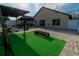 Backyard featuring a stone patio, outdoor seating, and green artificial turf at 2822 Moultrie Creek Dr, Kissimmee, FL 34743