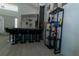 Open-concept bar features gray countertops, black barstools, and a liquor display at 2822 Moultrie Creek Dr, Kissimmee, FL 34743