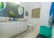 Bright bathroom featuring a modern vanity, granite countertop, vessel sinks, and decorative wall paneling at 2822 Moultrie Creek Dr, Kissimmee, FL 34743