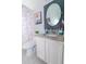 Cozy bathroom with a vanity featuring a granite countertop, a shower with a decorative curtain, and round mirror at 2822 Moultrie Creek Dr, Kissimmee, FL 34743