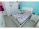 Well-lit bedroom features a comfortable bed, bright color accent wall, and natural light at 2822 Moultrie Creek Dr, Kissimmee, FL 34743