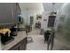 Bright kitchen with stainless steel appliances, tiled floors, granite countertops, and ample cabinet space at 2822 Moultrie Creek Dr, Kissimmee, FL 34743