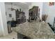 Modern kitchen features granite countertops, stainless steel appliances, and a stylish mosaic backsplash at 2822 Moultrie Creek Dr, Kissimmee, FL 34743