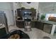 Modern kitchen with granite countertops, tile backsplash, stainless steel appliances, and a breakfast bar at 2822 Moultrie Creek Dr, Kissimmee, FL 34743