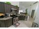Modern kitchen features stainless steel appliances, granite countertops, and dark wood cabinets at 2822 Moultrie Creek Dr, Kissimmee, FL 34743