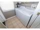 Functional laundry room equipped with a washer, dryer, and window, offering a dedicated space for laundry tasks at 2822 Moultrie Creek Dr, Kissimmee, FL 34743