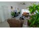 Bright living room boasts large windows, comfortable sofas, and decorative house plants at 2822 Moultrie Creek Dr, Kissimmee, FL 34743